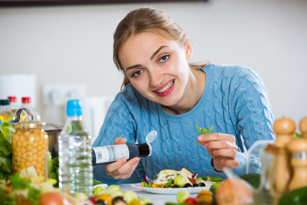 Haapy,Young,Woman,In,Pullover,Preparing,Salad,At,Domestic,Kitchen